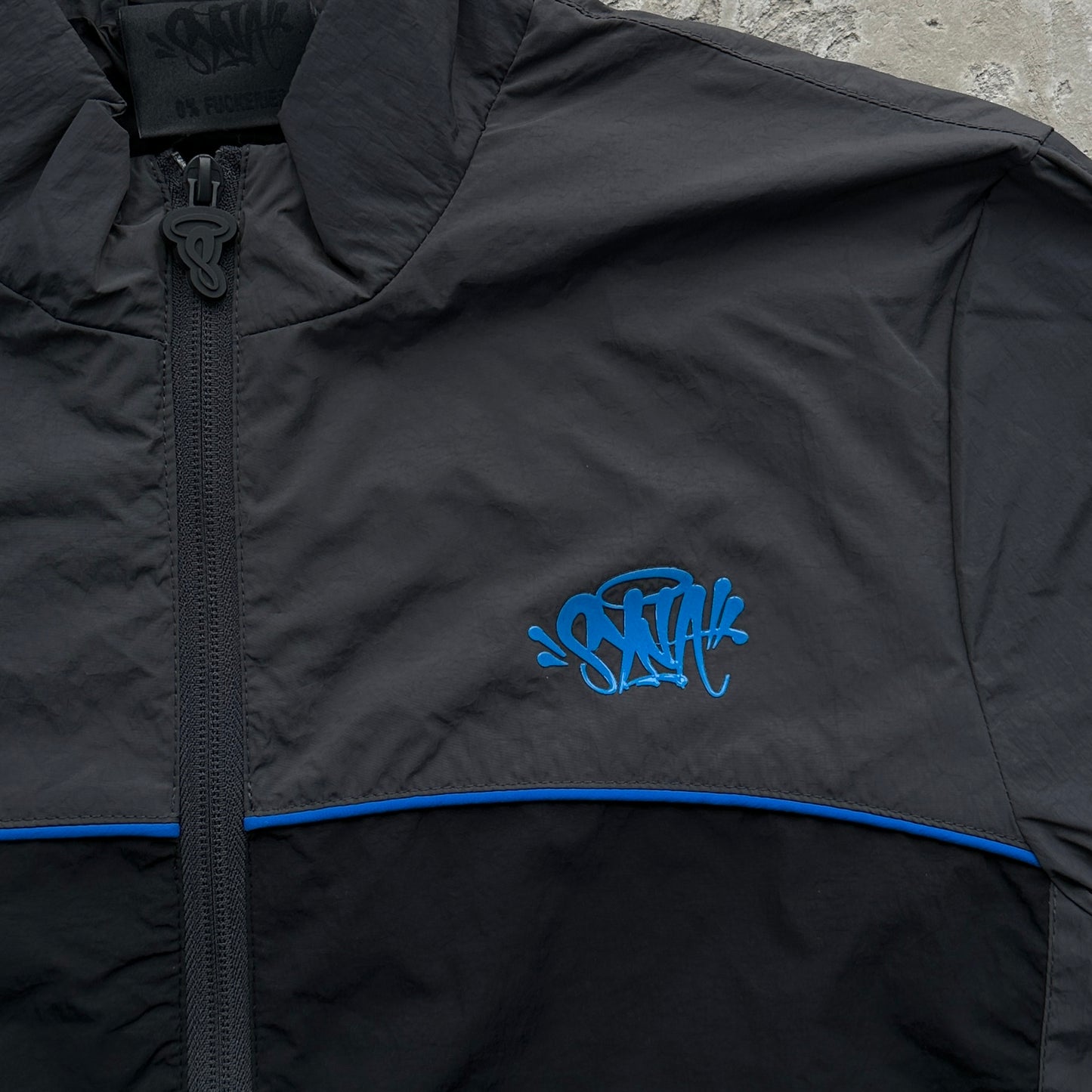 Conjunto Corta Vento SYNA World Preto e Azul